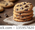 Stack of oatmeal cookies with chocolate chips. Luxury pastry dessert presentation. Bakery branding, cafe menu, holiday treat, confectionery, comfort food concepts and commercial food photography. 135957820