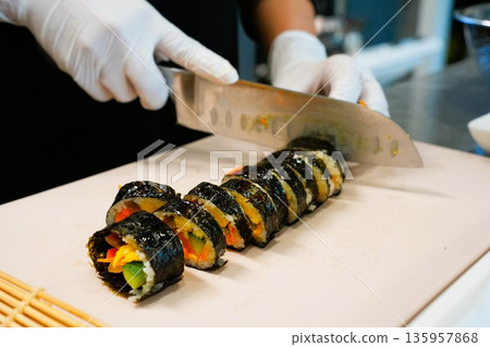 Korean Kimbap: The Culinary Process of Rolling and Slicing Gimbap 135957868