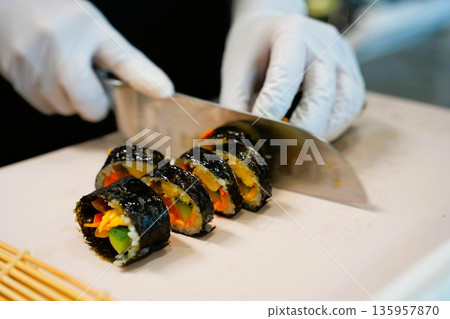Korean Kimbap: The Culinary Process of Rolling and Slicing Gimbap 135957870