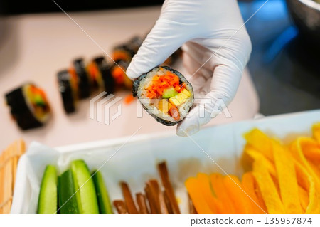 Korean Kimbap: The Culinary Process of Rolling and Slicing Gimbap 135957874