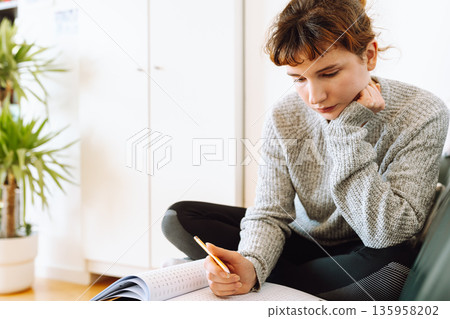 young woman writing notebook 135958202