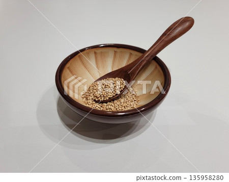 Sesame Seeds or Perilla Seeds in Traditional Ceramic Bowl and Mortar 135958280