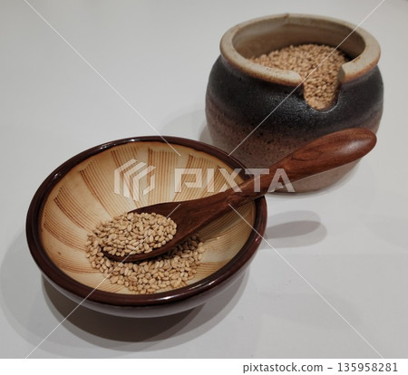 Sesame Seeds or Perilla Seeds in Traditional Ceramic Bowl and Mortar Sesame Seeds or Perilla Seeds in Traditional Ceramic Bowl and Mortar 135958281