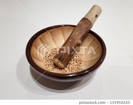 Sesame Seeds or Perilla Seeds in Traditional Ceramic Bowl and Mortar Sesame Seeds or Perilla Seeds in Traditional Ceramic Bowl and Mortar 135958283