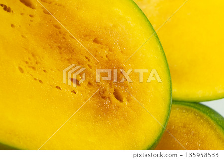 Macro Texture of Slice of Overripe Fresh Mango. 135958533