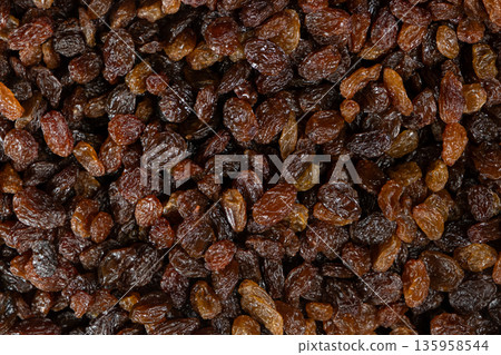 Macro top view of dried grapes, sweet organic raisins. Macro top view of dried grapes, sweet organic raisins. 135958544
