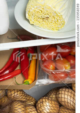 Fresh vegetables in a refrigerator drawer, potatoes and peppers Fresh vegetables in a refrigerator drawer, potatoes and peppers 135958549