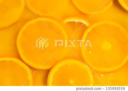Orange slices swimming in fresh orange juice, horizontal macro. Orange slices swimming in fresh orange juice, horizontal macro. 135958559