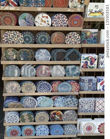 Colorful ceramic tiles displayed in rows featuring intricate patterns in varied designs Colorful ceramic tiles displayed in rows featuring intricate patterns in varied designs 135958583