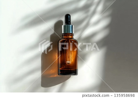 cosmetic makeup bottle serum dropper product with skin care concept on light background in leaf shadows. cosmetic makeup bottle serum dropper product with skin care concept on light background in leaf shadows. 135958698