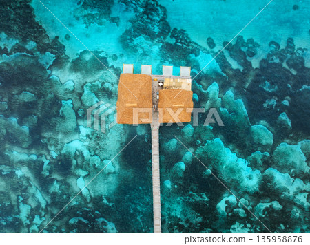Aerial view of bungalow, jetty, blue sea on summer sunny day 135958876