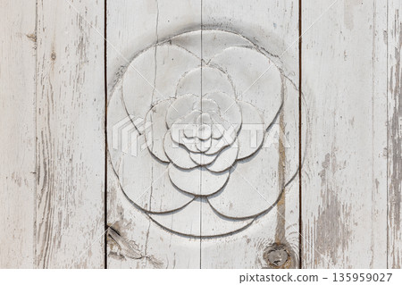 A white wood plank background features a circular rosette 135959027