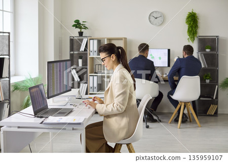 Professional accountant working with reports and calculator in modern office 135959107