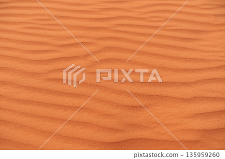 Desert patterns of wind-sculpted sand dunes in Wadi Ram located in the Sahara during sunsets warm glow Desert patterns of wind-sculpted sand dunes in Wadi Ram located in the Sahara during sunsets warm glow 135959260