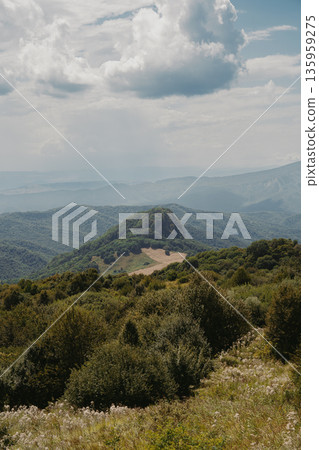 Gombori Mountain of Georgia display vast green hills and blue skies with clouds visible on the horizon Gombori Mountain of Georgia display vast green hills and blue skies with clouds visible on the horizon 135959275