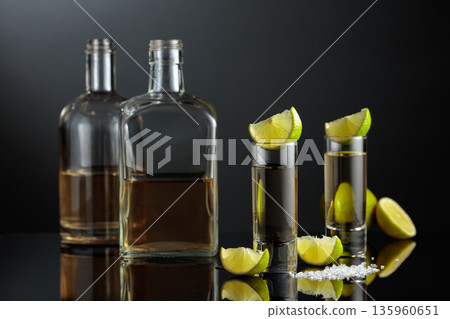 Gold tequila with sea salt and lime slices. 135960651