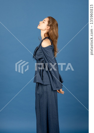 Woman posing in stylish blue modern fashion outfit 135960815