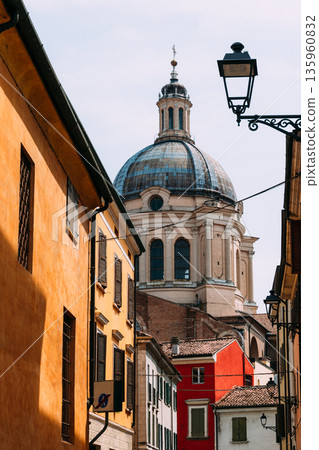 A picturesque view of Mantua architecture with a stunning dome and colorful buildings. A picturesque view of Mantua architecture with a stunning dome and colorful buildings. 135960832