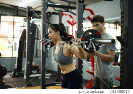Sport session woman squat and lifting weights with her trainer, Photo set 135960915
