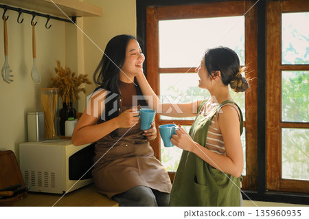 lgbt woman love moment in kitchen with a coffee morning lgbt woman love moment in kitchen with a coffee morning 135960935