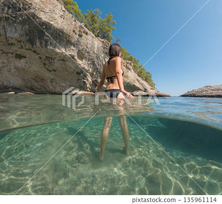 Woman on tropical vacation paradise on sea. Summer sea joy in Turkish seacoast, beaches along Lycian Way, Turkish Riviera. Asian female underwater and turquoise ocean around. 135961114