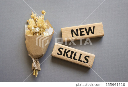 New skills symbol. Wooden blocks with words New skills. Beautiful grey background. Business and New skills concept. Copy space. New skills symbol. Wooden blocks with words New skills. Beautiful grey background. Business and New skills concept. Copy space. 135961318