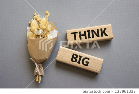 Think big symbol. Wooden blocks with words Think big. Beautiful grey background. Business and Think big concept. Copy space. Think big symbol. Wooden blocks with words Think big. Beautiful grey background. Business and Think big concept. Copy space. 135961322