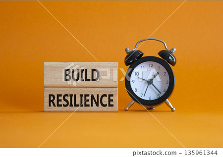 Build resilience symbol. Wooden blocks with words Build resilience. Beautiful orange background with alarm clock. Business and Build resilience concept. Copy space. Build resilience symbol. Wooden blocks with words Build resilience. Beautiful orange background with alarm clock. Business and Build resilience concept. Copy space. 135961344