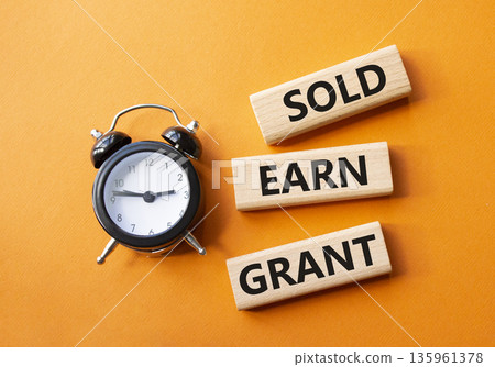 Sold Earn Grant symbol. Concept words Sold Earn Grant on wooden blocks. Beautiful orange background with alarm clock. Business and Sold Earn Grant concept. Copy space. Sold Earn Grant symbol. Concept words Sold Earn Grant on wooden blocks. Beautiful orange background with alarm clock. Business and Sold Earn Grant concept. Copy space. 135961378