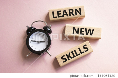 Learn new skills symbol. Concept words Learn new skills on wooden blocks. Beautiful pink background with alarm clock. Business and Learn new skills concept. Copy space. Learn new skills symbol. Concept words Learn new skills on wooden blocks. Beautiful pink background with alarm clock. Business and Learn new skills concept. Copy space. 135961380
