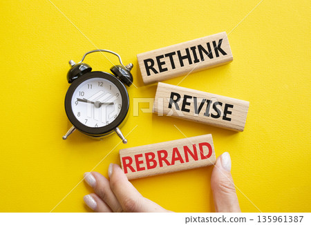 Rethink Revise Rebrand symbol. Wooden blocks with words Rethink Revise Rebrand. Businessman hand. Beautiful yellow background with alarm clock. Business and Rethink Revise Rebrand concept. Copy space. Rethink Revise Rebrand symbol. Wooden blocks with words Rethink Revise Rebrand. Businessman hand. Beautiful yellow background with alarm clock. Business and Rethink Revise Rebrand concept. Copy space. 135961387