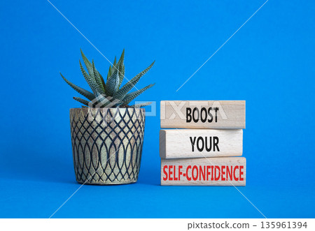 Self-confidence symbol. Concept word Boost your Self-confidence on wooden blocks with succulent. Beautiful blue background. Business lifestyle and Self-confidence concept. Copy space 135961394