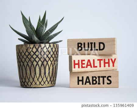 Healthy habits symbol. Concept word Build Healthy habits on wooden blocks with succulent. Beautiful white background. Healthy lifestyle and Healthy habits concept. Copy space 135961409