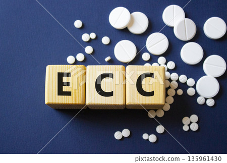 ECC symbol. Wooden cubes with words ECC Emergency Cardiovascular Care. Beautiful deep blue background. Healthcare and Emergency Cardiovascular Care concept. Copy space. 135961430