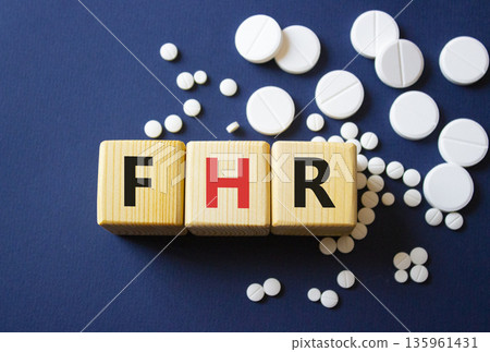 FHR symbol. Wooden cubes with words FHR Fetal Heart Rate. Beautiful deep blue background. Healthcare and Fetal Heart Rate concept. Copy space. FHR symbol. Wooden cubes with words FHR Fetal Heart Rate. Beautiful deep blue background. Healthcare and Fetal Heart Rate concept. Copy space. 135961431