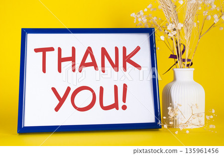 Thank you symbol. Concept words Thank you on beautiful wooden picture frame. Beautiful yellow background with flower vase. Business and Thank you concept. Copy space. 135961456