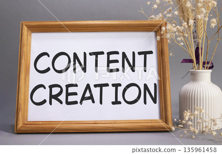 Content creation symbol. Concept words Content creation on beautiful wooden picture frame. Beautiful grey background with flower vase. Business and Content creation concept. Copy space. Content creation symbol. Concept words Content creation on beautiful wooden picture frame. Beautiful grey background with flower vase. Business and Content creation concept. Copy space. 135961458