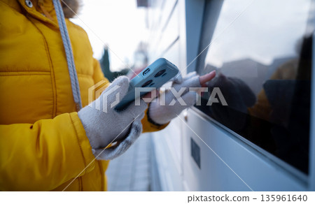 Girl Picking Up A Parcel From Parcel Automated Locker 135961640