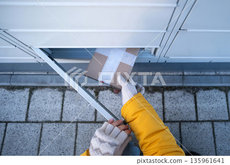 Girl Picking Up A Parcel From Parcel Automated Locker 135961641