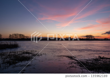 Sunset view of the frozen lake 135962189