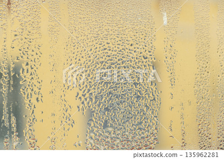 Wet window glass surface with heavy moisture and misted texture. 135962281