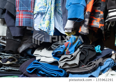 Space organization in the wardrobe, real view inside the wardrobe with clothes Space organization in the wardrobe, real view inside the wardrobe with clothes 135962291