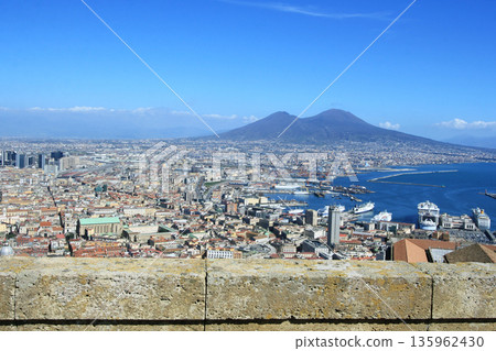 Scenic view of the city of Napoli with famous Mount Vesuvius in the background at sunset in Italy Scenic view of the city of Napoli with famous Mount Vesuvius in the background at sunset in Italy 135962430
