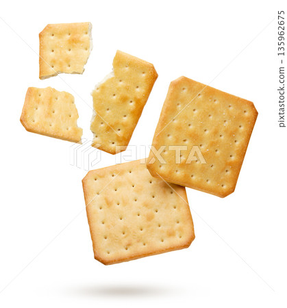 Crackers and broken pieces flying on a white background. Isolated 135962675