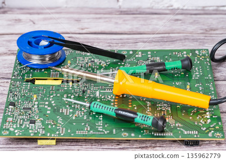 electrical board with a soldering iron and screwdrivers electrical board with a soldering iron and screwdrivers 135962779