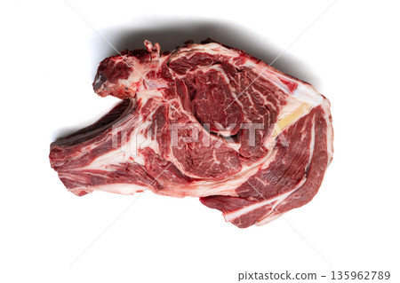 Raw beef ribeye steak isolated on white background. Fresh uncooked meat cut with bone and marbling. Top view flat lay Raw beef ribeye steak isolated on white background. Fresh uncooked meat cut with bone and marbling. Top view flat lay 135962789