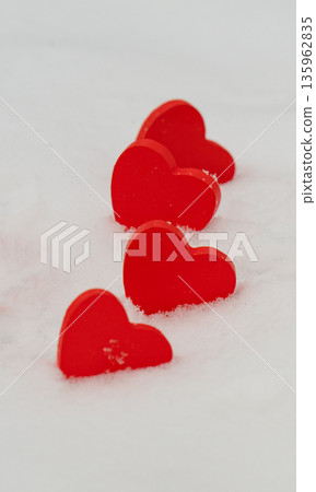 red hearts on the snow= 135962835