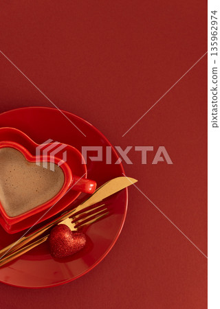 Heart Shaped Coffee Cup with Glittered Candy. Romantic Valentines Day Table Setting on Red Background Heart Shaped Coffee Cup with Glittered Candy. Romantic Valentines Day Table Setting on Red Background 135962974