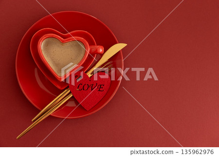 Heart Shaped Coffee Cup with Felt Heart.  Romantic Valentines Day Table Setting on Red Background 135962976