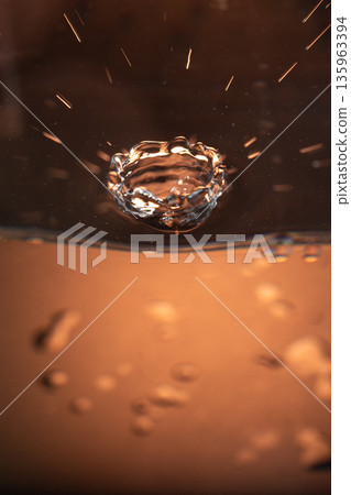195.Crown Splash with Amber Background and Ripples 135963394